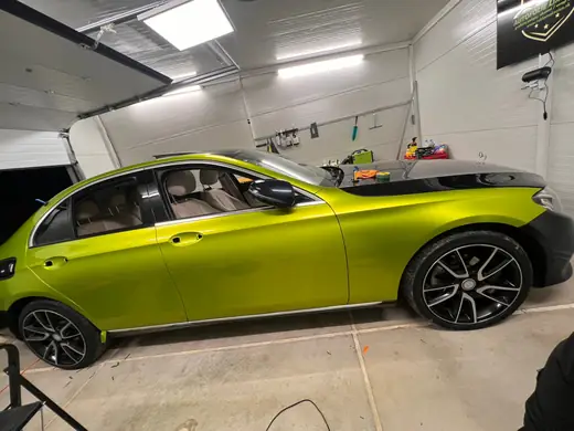 Mercedes E-Class v limetkovej fólii s čiernou kapotou — bočný pohľad